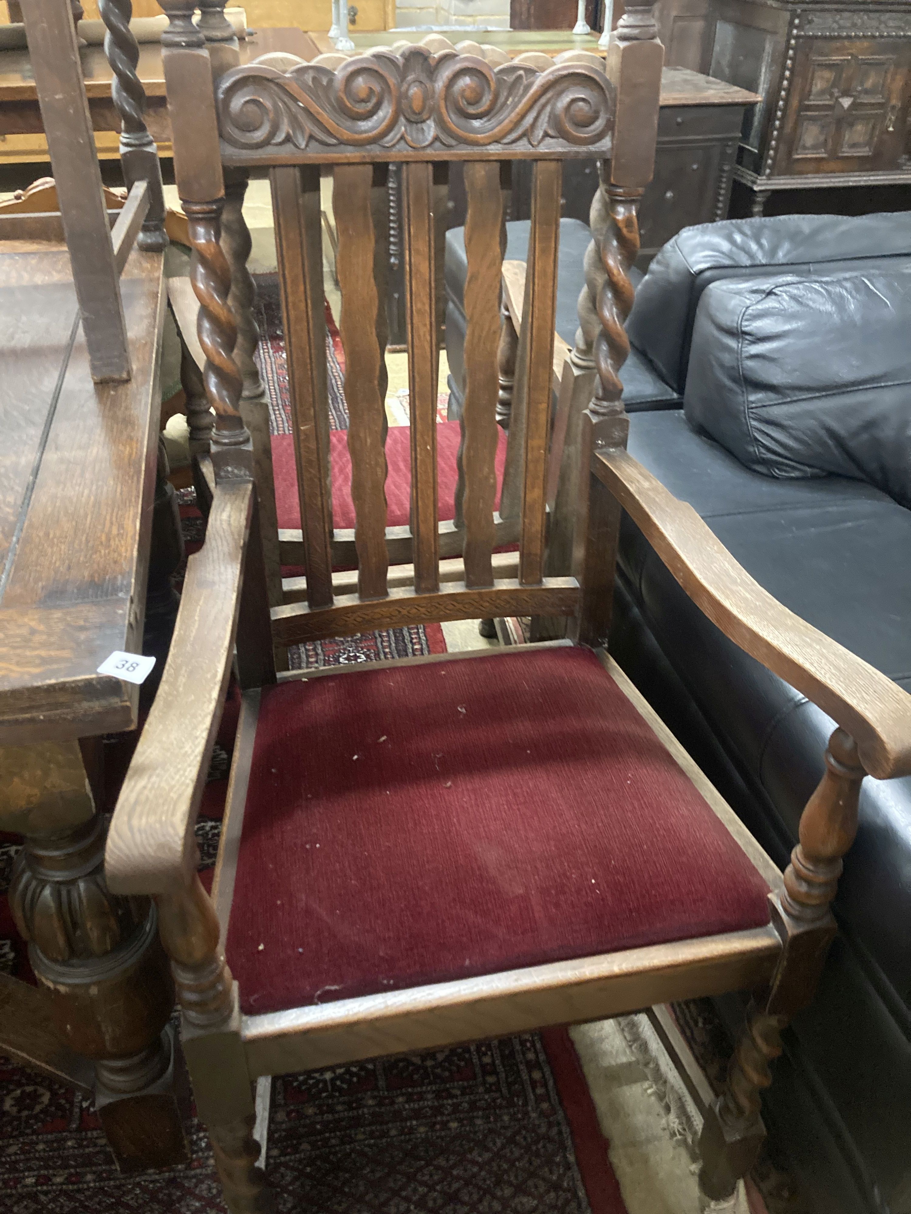 A set of six 1920s oak Carolean style dining chairs (two with arms) and an oak draw leaf dining table, width 137cm, depth 106cm, heigh